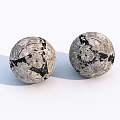 Two Black And White Patterned Spherical Sports Equipment Balls With Textured Surface Design