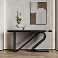Modern Black Console Table with Z Shaped Legs Decorative Vase Green Plant Neutral Wall Art