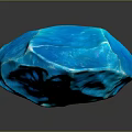 Blue Carved Sculpture with Geometric Facets and Shiny Reflective Surface on Gray Background