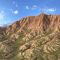 Scenic Mountain Landscape With Rolling Brownish Yellow Peaks Green Grass Blue Sky And White Clouds