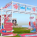 Vibrant Event Entrance Featuring Red And White Checkered Tents On Grass With Pink Flower Decorations