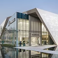 Modern Geometric Sales Office Building With Glass Facade And Water Reflection