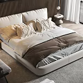 Modern Double Bed with Wooden Headboard Plush Bedding and Accent Chair in Bright Bedroom