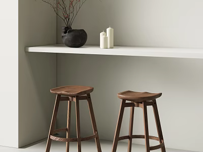 Two Wooden Bar Stools Under White Countertop With Black Vase And White Candles 3d model