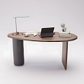 Oval Shaped Wooden Office Desk with Laptop Desk Lamp Books And Small Figurine