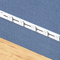 White Power Strip With Multiple Outlets On Blue Fabric And Wooden Surface
