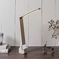 Modern LED Desk Lamp with Sleek Adjustable Arm on Wooden Table with Books and Plants