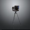 Vintage Electronic Camera With Blue Decorated Body On Metal Tripod Stand