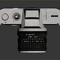 Canon Vintage Camera With Silver Black Body And Lens On Reflective Surface