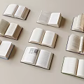 Multiple Open Books Arranged in Various Angles on Light Colored Background