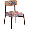 Vibrant Accent Chair With Colorful Patterned Seat Wooden Armrests And Green Throw Blanket