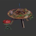 Rustic Round Wooden Table With Red Stool Cups Knife And Fishing Rod