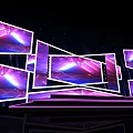Commercial Equipment Stage Setup With Multiple Displays And Purple Blue Lighting