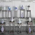 Traditional Blue and White Ceramic Vessels on Wooden Stands with Brick Wall and Green Plants