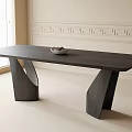 Modern Black Dining Table with Unique Curved Legs and White Bowl in Bright Light-Colored Room