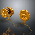 Pair of Golden Circular Clothing Accessories With Ornate Patterns And Decorative Stands
