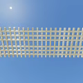 White Lattice Structure Outdoor Against Clear Blue Sky With Shining Sun