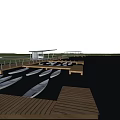 Scenic Dock View With Wooden Boardwalk Small Boats Open Water Blue Sky And Green Grass