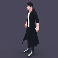 A Man Wearing Black Long Coat White T-shirt Dark Pants and Sneakers Against Gray Background