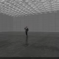 Businessman In Suit Talking On Phone In Large Empty Room With Ceiling Lights