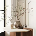 Terracotta Vase With Green Branches And Red Berries On Round Table With White Statue