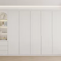 Modern White Wardrobe with Panel Doors and Open Shelving Unit Featuring Decorative Items in Minimalist Space