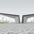 Modern Entrance Gate With Wing Shaped Metal Structure In Urban Square With Trees And Buildings