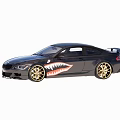 Black Two Door Coupe Car With Gold Wheels And Shark Mouth Graphic