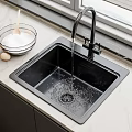 Modern Black Kitchen Sink with Faucet Running Water and Fresh Ingredients on Marble Countertop