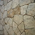 Natural Stone Wall with Irregular Shaped Tiles and Varied Gray Brown Tones Rustic Textured Surface