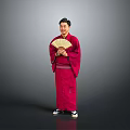 Man In Red Kimono Holding A Folding Fan Against Gray Background
