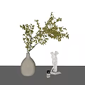 White Vase With Green Foliage Next To White Statue And Small Candle On White Table
