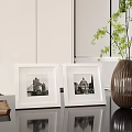 Black Picture Frames With Architectural Photos On Round Coffee Table In Living Room