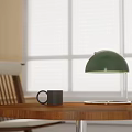 Wooden Table With Green Desk Lamp Black Mug Chair And Window Background