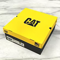 Vibrant Yellow CAT Logo Packaging Box For Lifestyle Product On Marble Surface