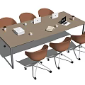 Wooden Conference Table With Orange Rolling Chairs Laptops Printer Coffee Cups And Documents