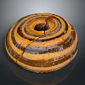 Circular Spiral Sculpture With Brown And Yellow Striped Textured Surface And Cracks