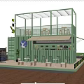 Green Container Café With Two Story Structure Outdoor Terrace And Lush Greenery