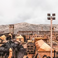 Desolate Desert Military Base With Tents Watchtower Mountains And Searchlights