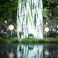 Stylish Garden Ornament Design With Hanging White Strips Round Lights And Water Reflections