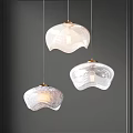 Three Modern Pendant Lights With Transparent Glass Shades Gold Accents Minimalist Interior Design