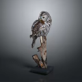 Realistic Owl Sculpture Perched on Wooden Branch with Black Base and Detailed Feather Texture