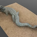 Realistic Crocodile Sculpture Lying On Sandy Surface With Detailed Textured Skin