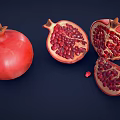 Fresh Red Pomegranate With Whole Fruit And Cut Open Sections Showing Juicy Arils 3d model