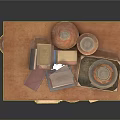 Artisanal Carved Clay Sculptures Displayed On Wooden Table With Books And Vessels