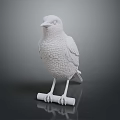 White Bird Statue Standing On Small Roll With Textured Feather Details Against Dark Background