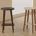 Two Modern Bar Stools With Round Tops Light And Dark Wooden Legs In Room