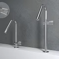 Sleek Modern Stainless Steel Faucets With Different Heights On White Countertop Grey Wall