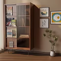 Cozy Room Interior Featuring Wooden Bookshelf With Glass Doors Books Wall Paintings And Potted Plant