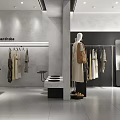 Modern Clothing Store Interior With Mannequins Displaying Dresses Clothes on Hangers and Display Table